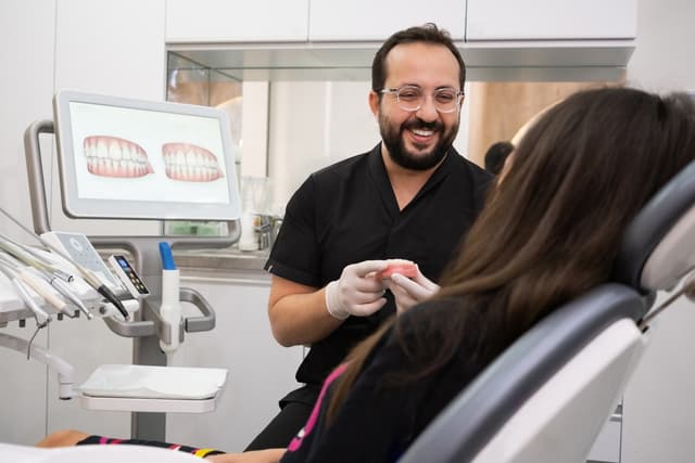 A dentist explaining a digital smile design to a patient